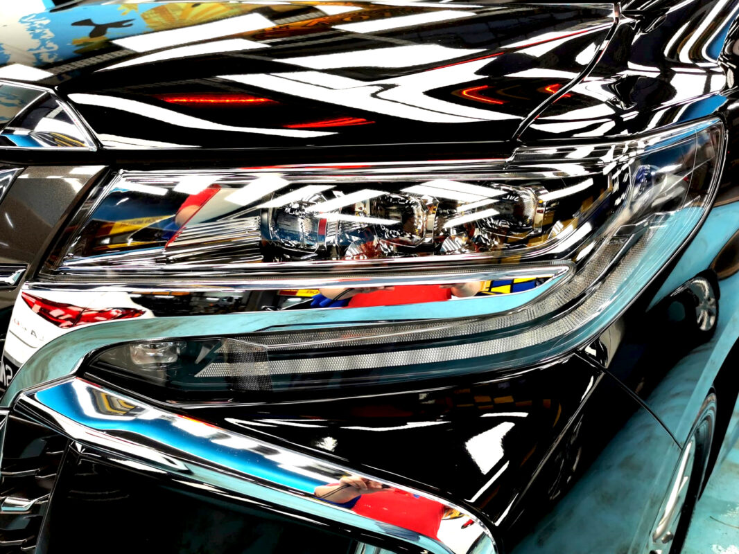 The Alphard's coated paintwork showing clean reflections.