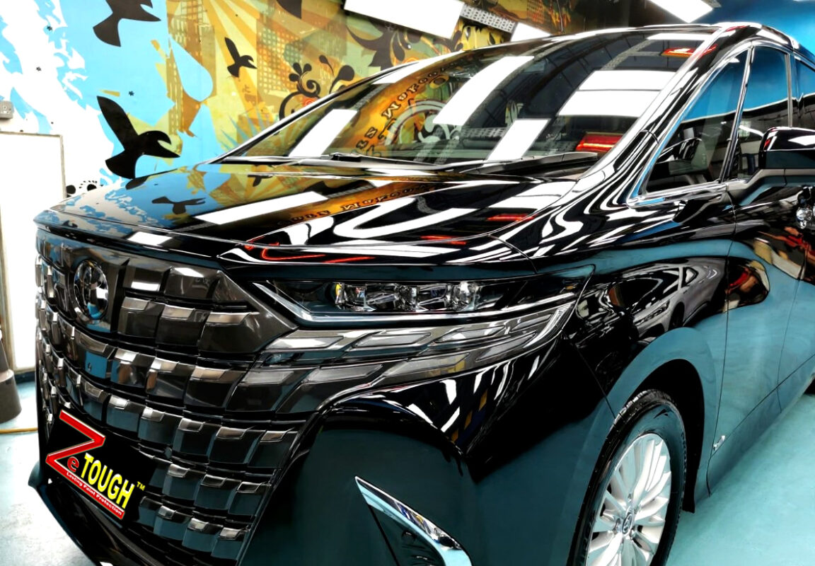 The Toyota Alphard's coated paintwork under workshop lighting.