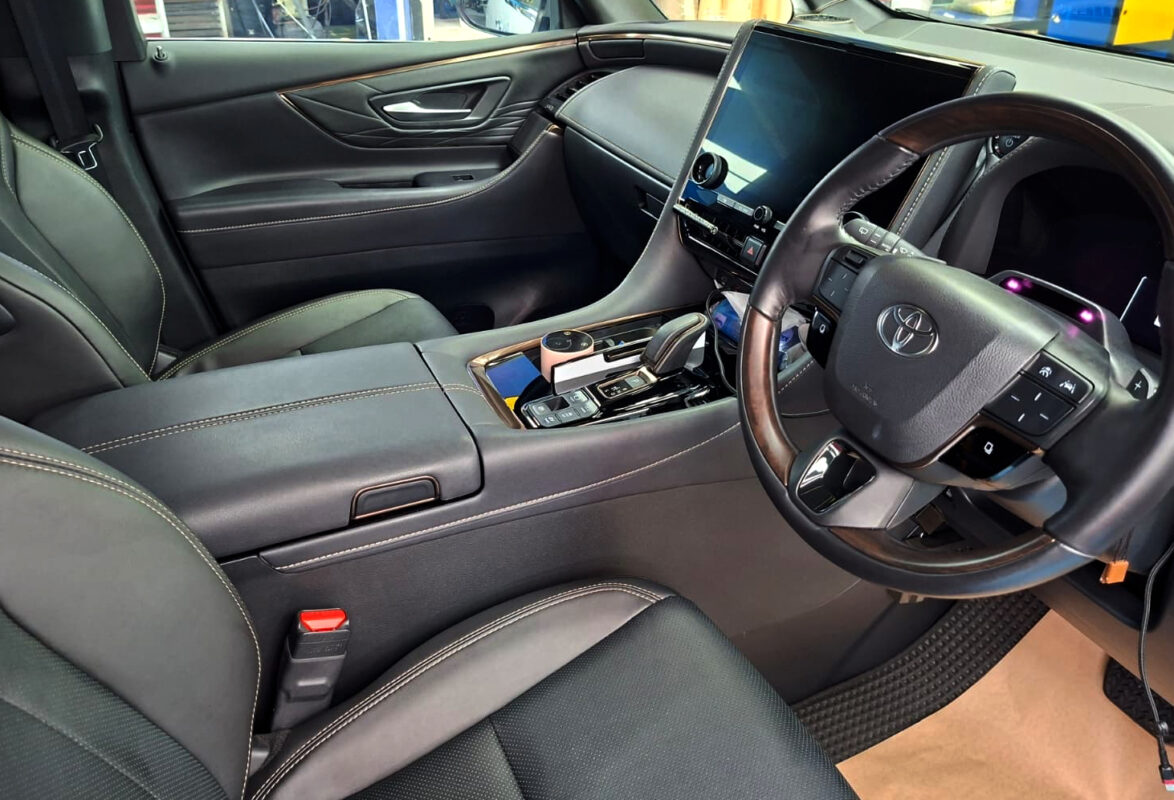 Reflections across the coated panels of the Toyota Alphard.