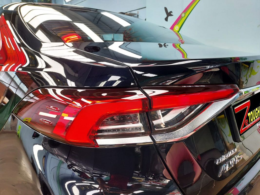 Rear quarter of the Toyota Altis, glossy and protected.