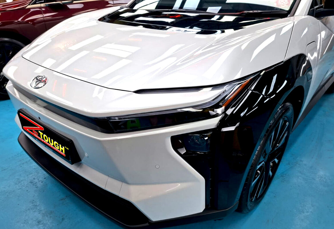 The Toyota bZ4X's coated paintwork under workshop lighting.