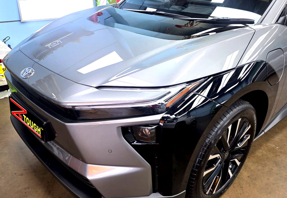 The Toyota bZ4X's coated paintwork under workshop lighting.