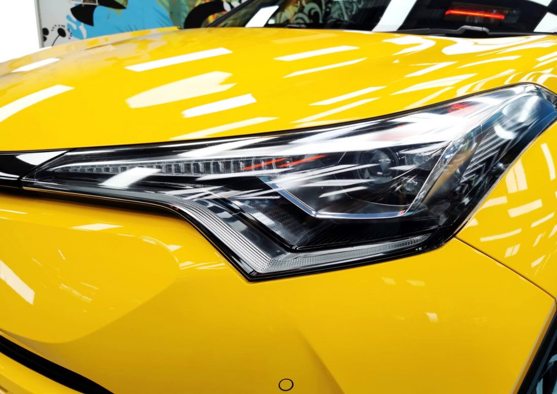 The C-HR Hybrid's coated paintwork showing clean reflections.