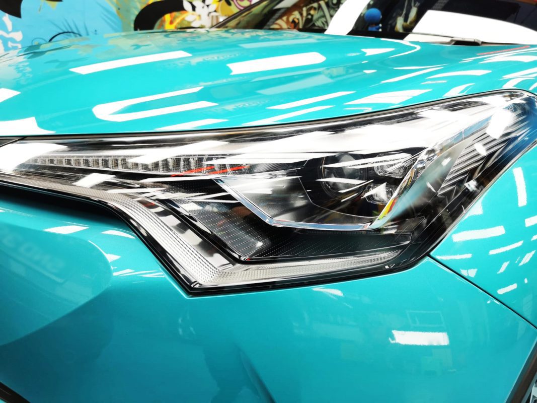 The C-HR's coated paintwork showing clean reflections.