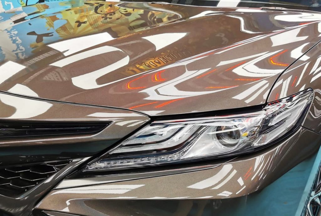 The Camry's coated paintwork showing clean reflections.