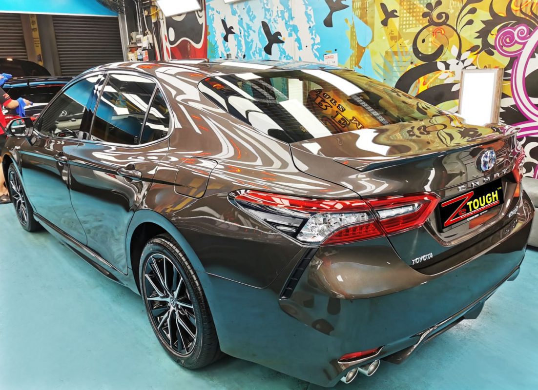 Rear quarter of the Toyota Camry, glossy and protected.