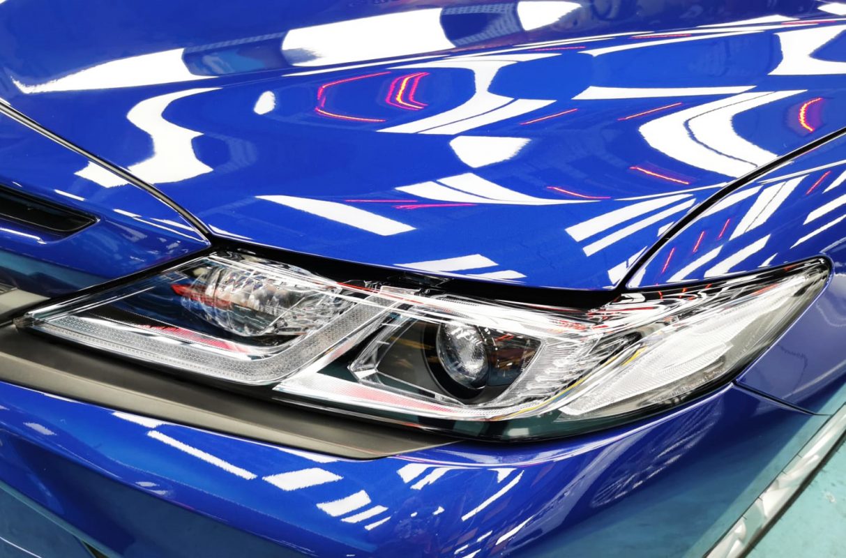 The Camry Hybrid's coated paintwork showing clean reflections.