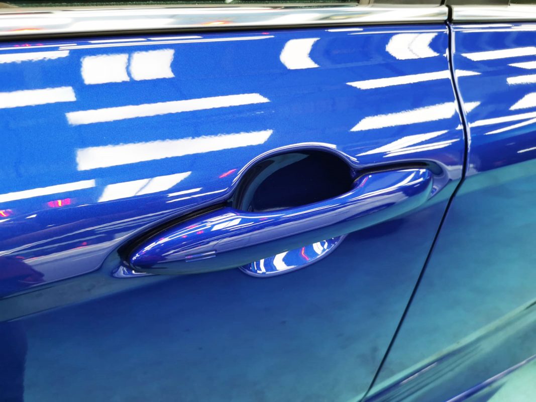 Front three-quarter view of the Toyota Camry Hybrid after coating.