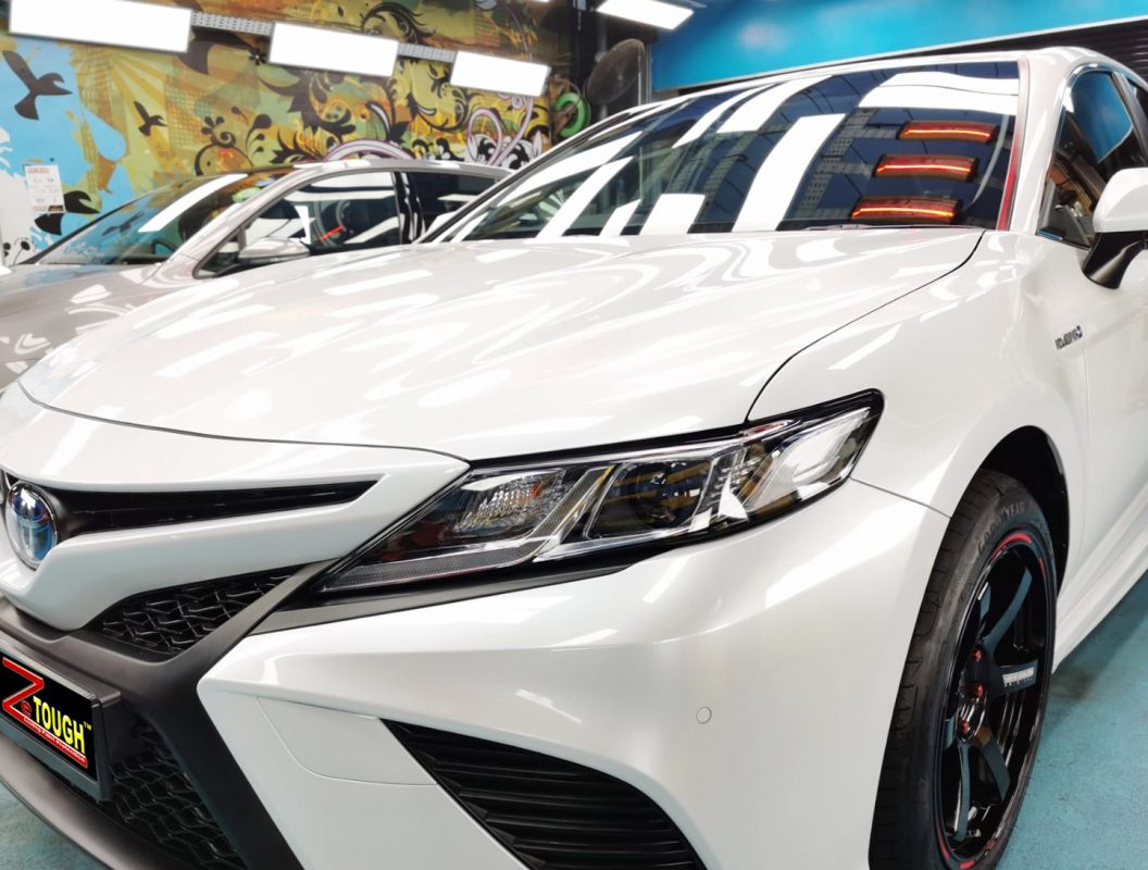 The Toyota Camry Hybrid from a side angle after the ceramic coating.