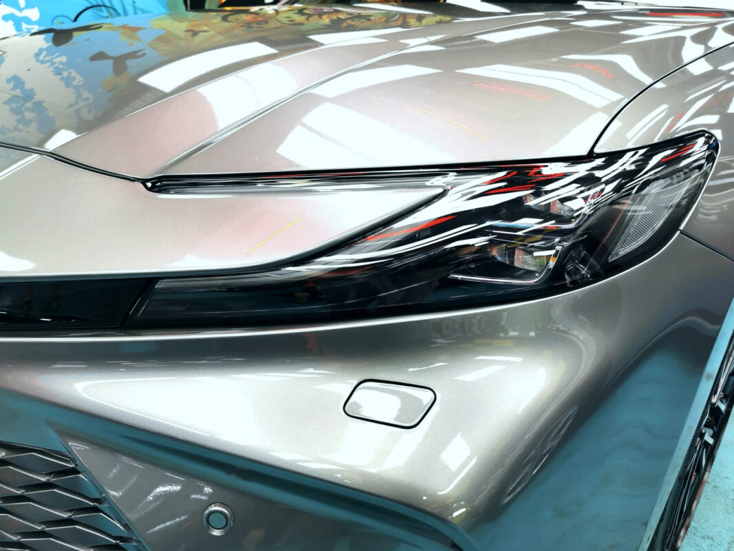 The Camry's coated paintwork showing clean reflections.