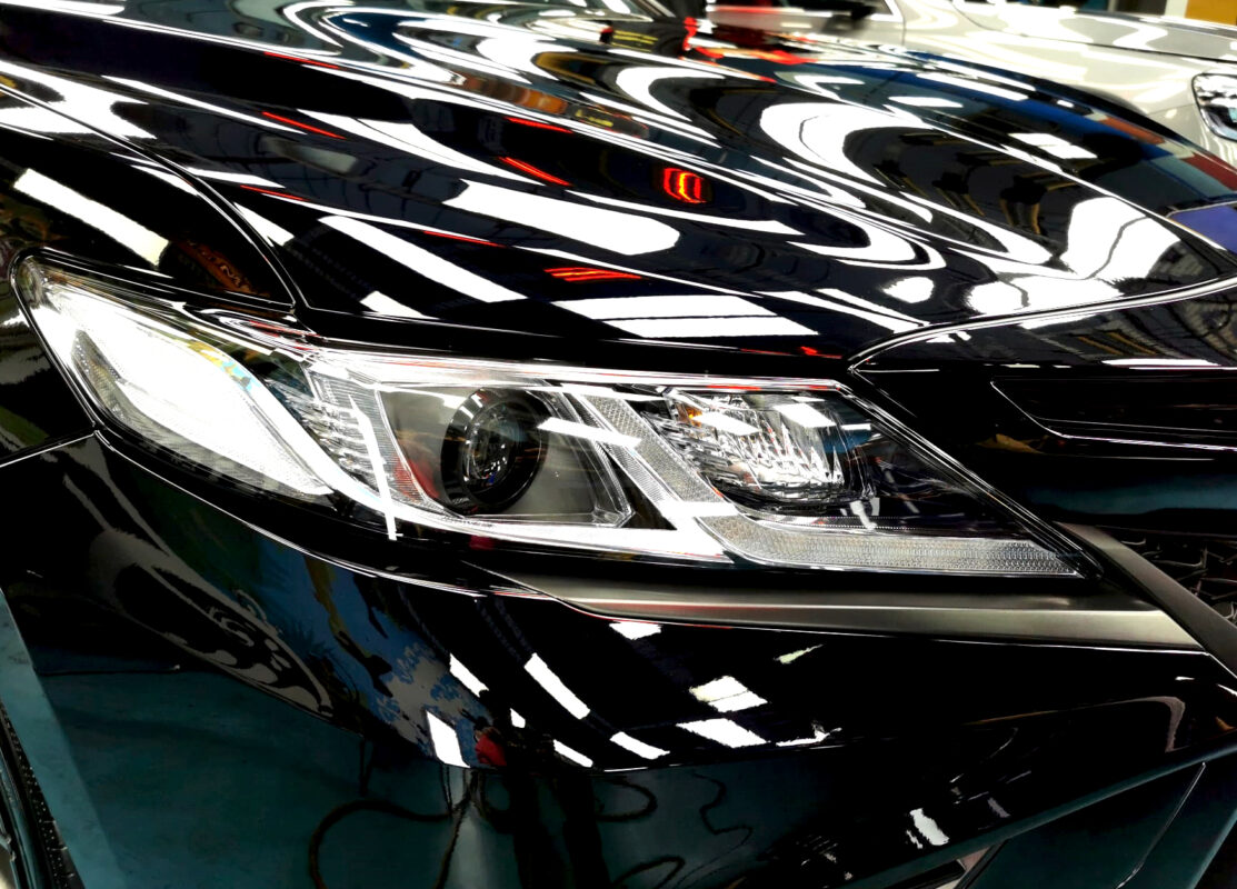 The Camry's coated paintwork showing clean reflections.