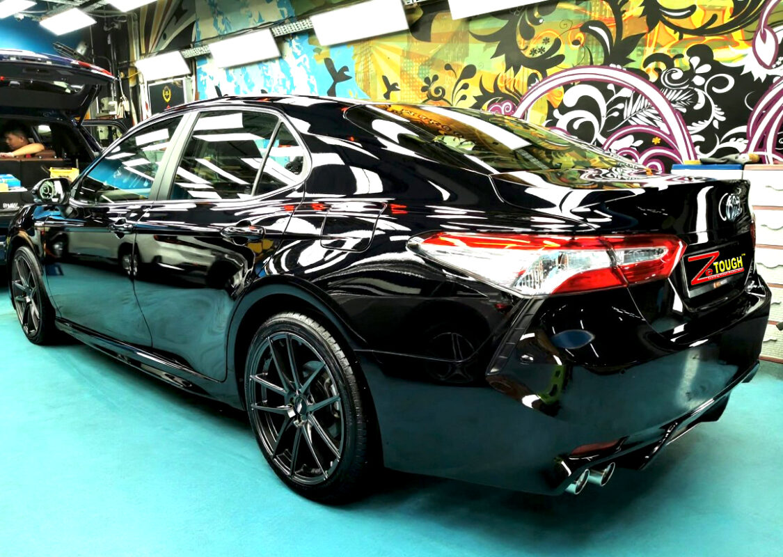 Rear quarter of the Toyota Camry, glossy and protected.