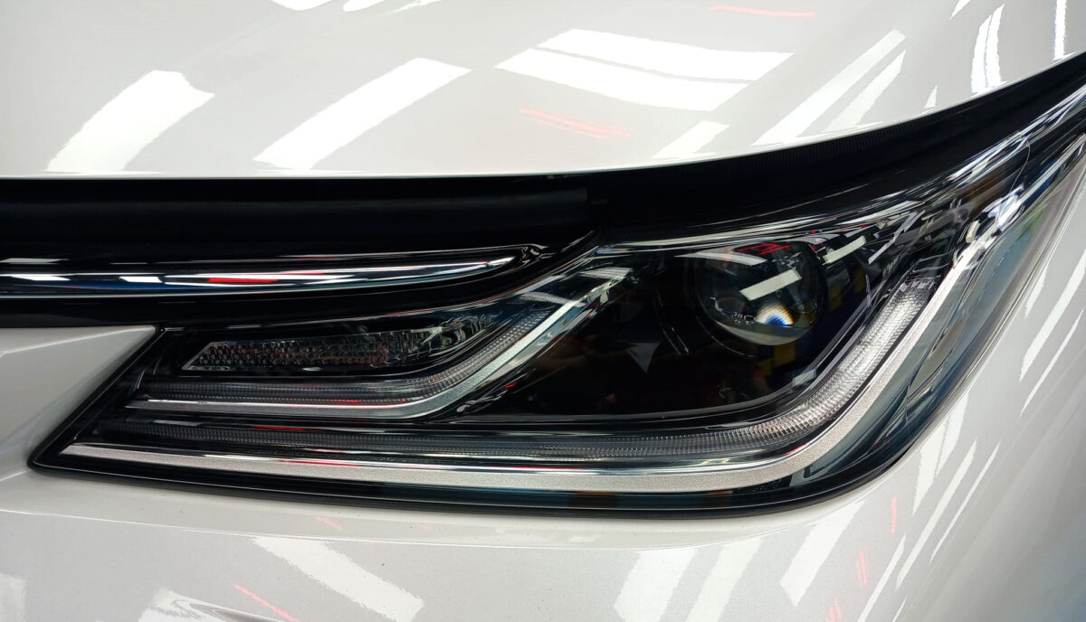 The Corolla Altis's coated paintwork showing clean reflections.