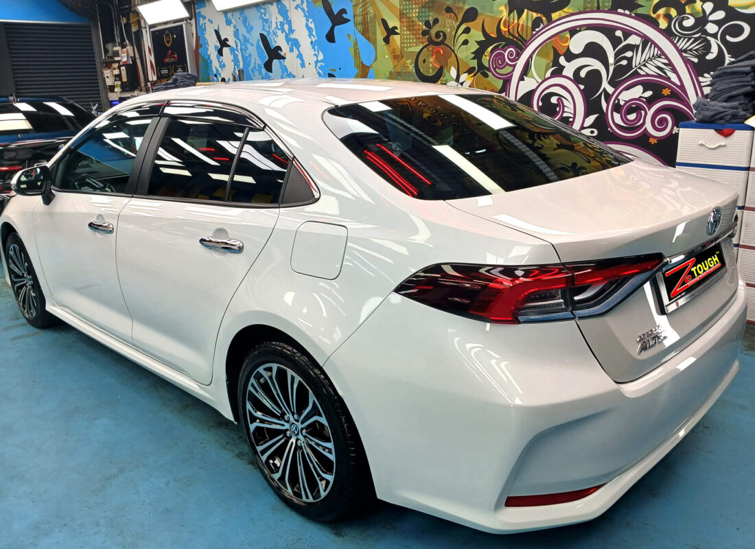 Rear quarter of the Toyota Corolla Altis, glossy and protected.