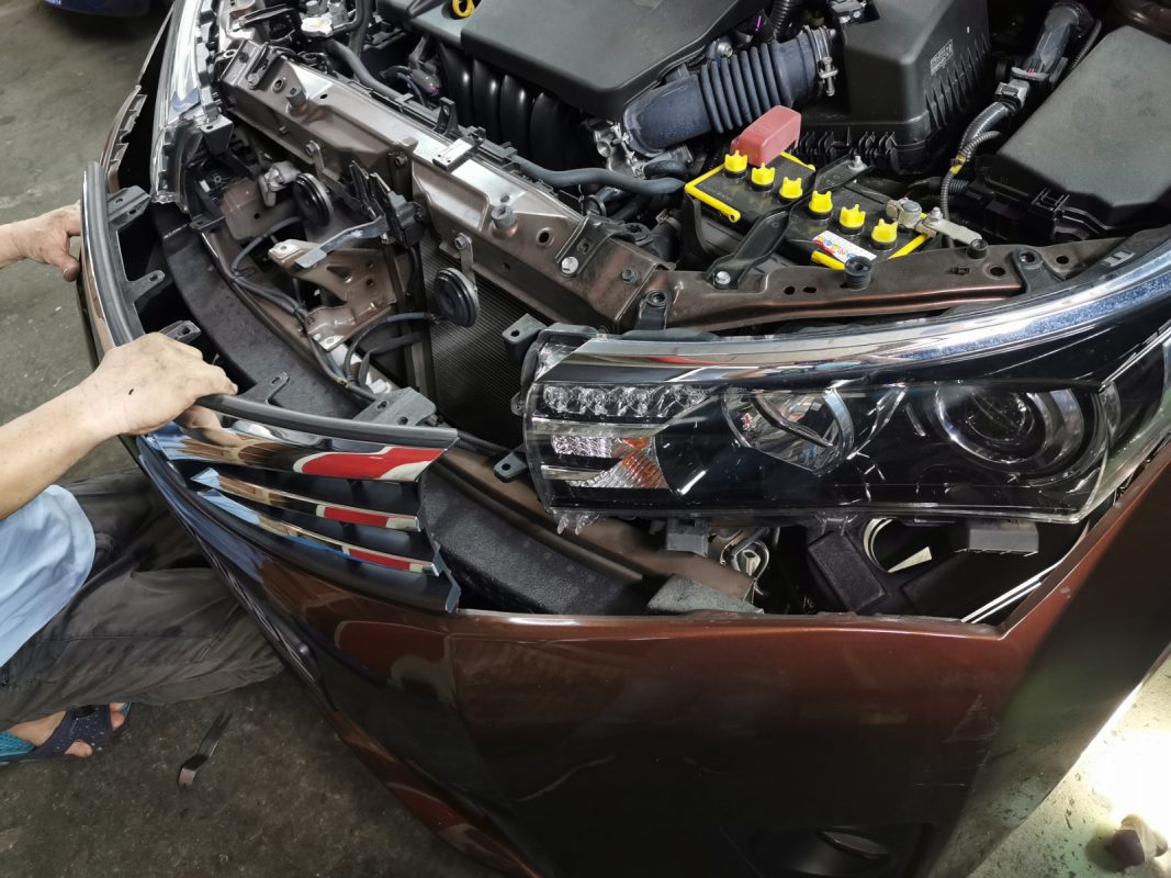 Necessary parts being dismantled from the Corolla Altis before spraying.