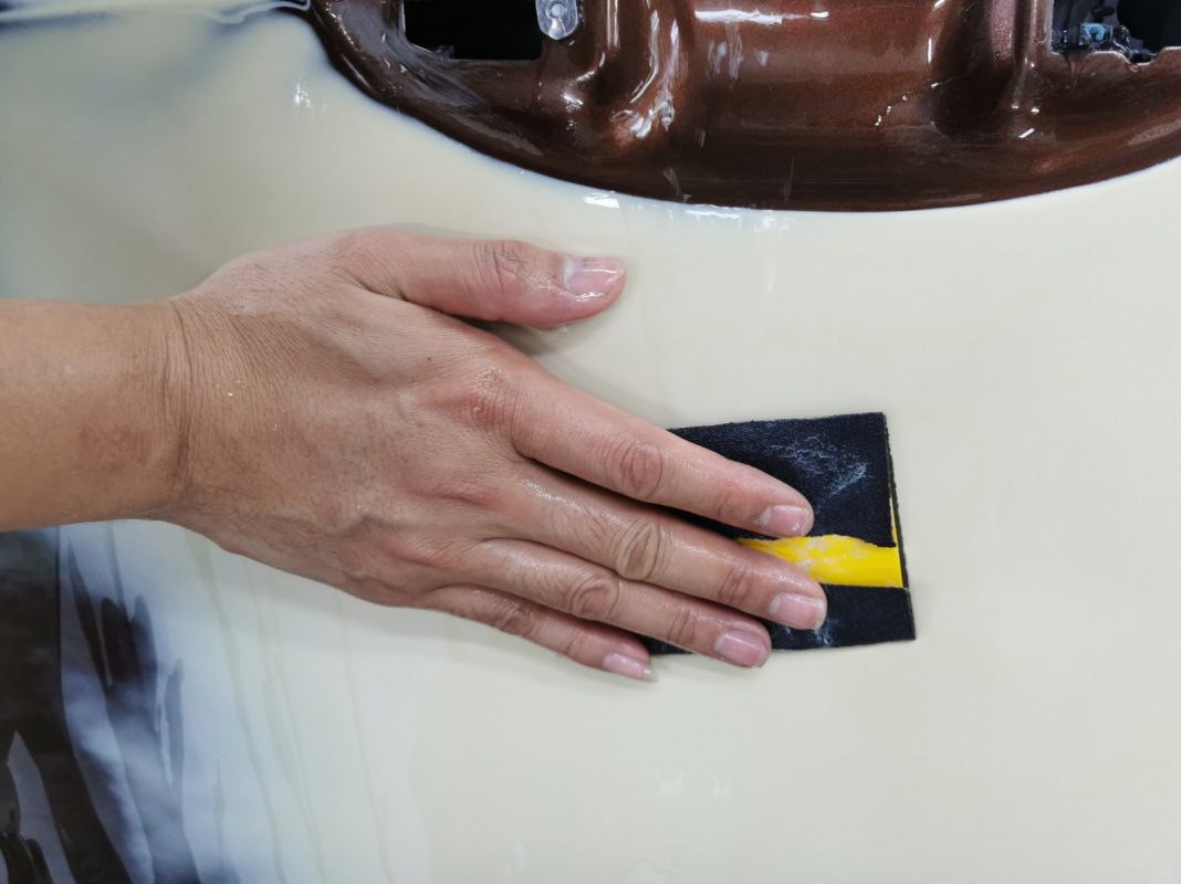 Wet-sanding the Corolla Altis panels to smooth the existing paintwork.