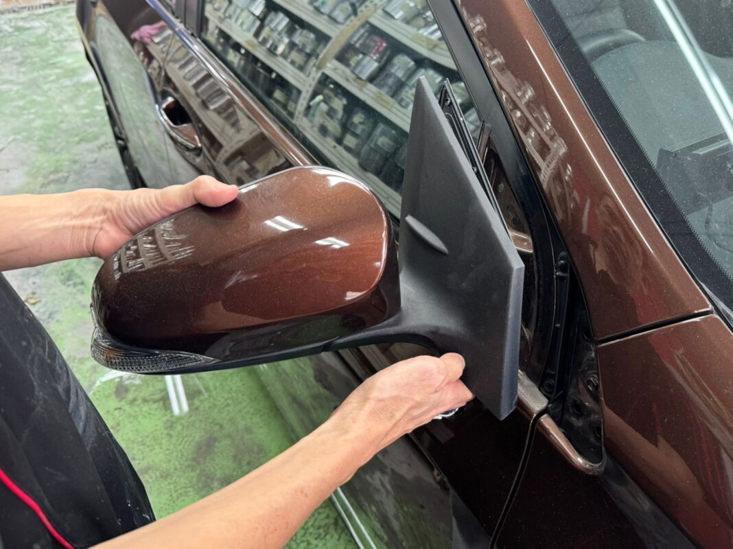 The side mirror cap removed as the Corolla Altis is stripped down for the respray.