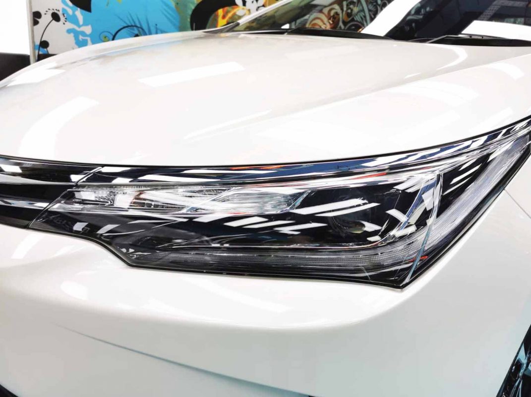 The Corolla Altis's coated paintwork showing clean reflections.
