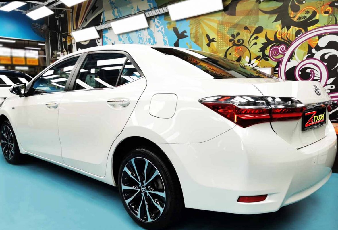 Rear quarter of the Toyota Corolla Altis, glossy and protected.