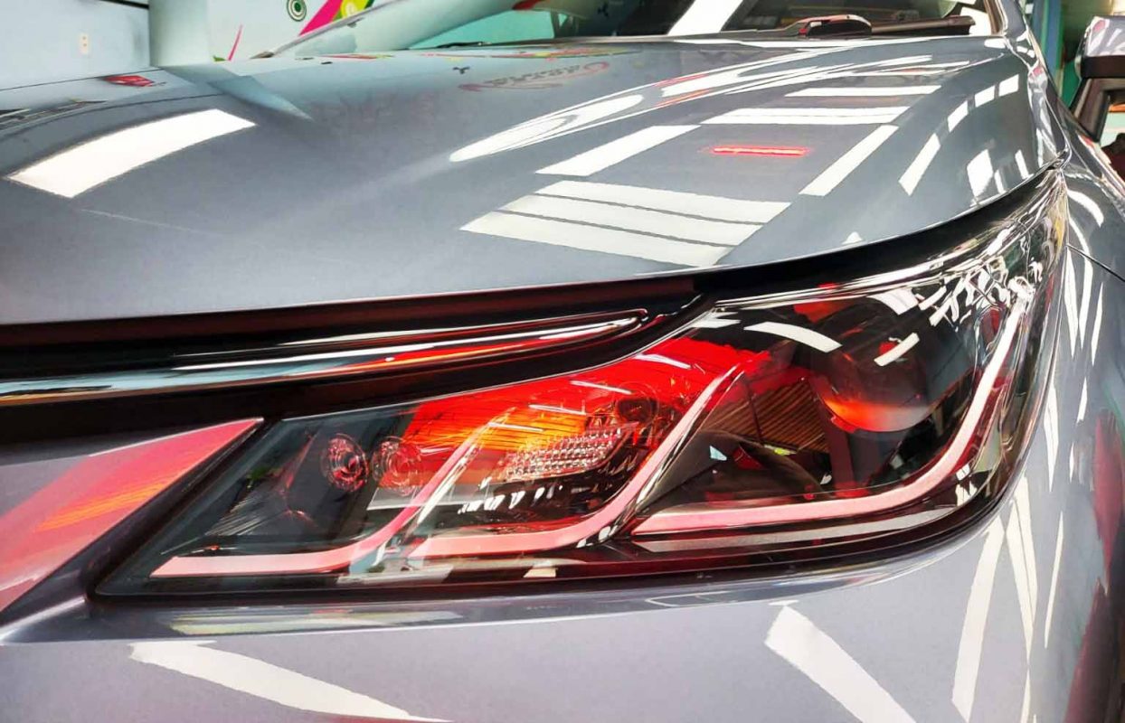 The Corolla Altis's coated paintwork showing clean reflections.
