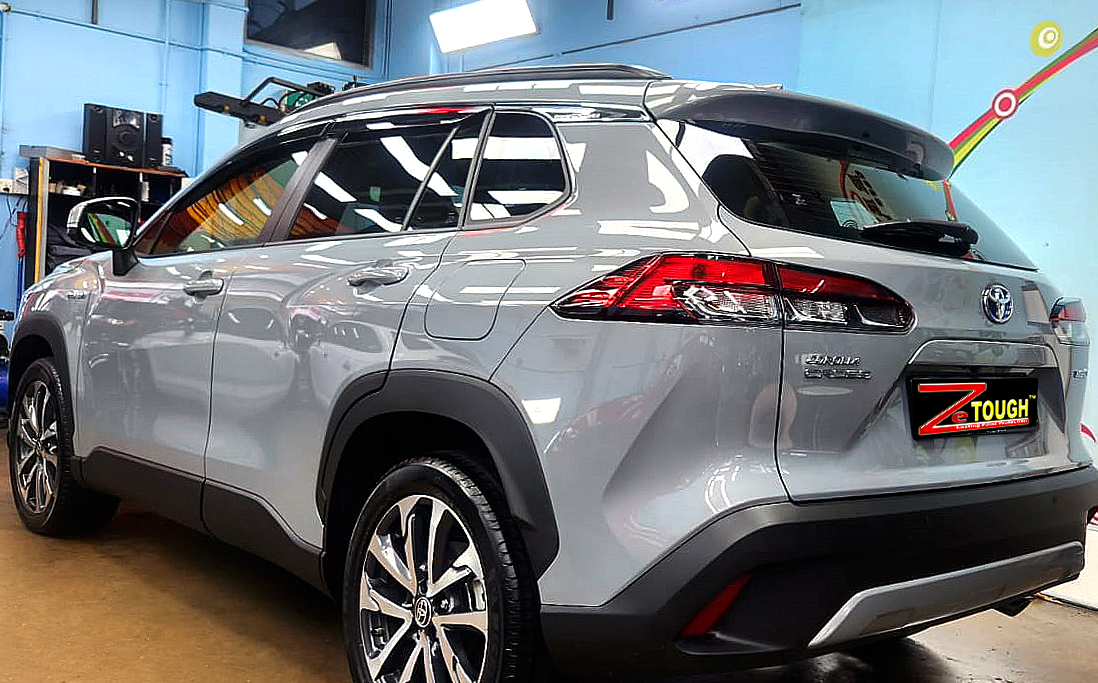 Rear quarter of the Toyota Corolla Cross Hybrid, glossy and protected.