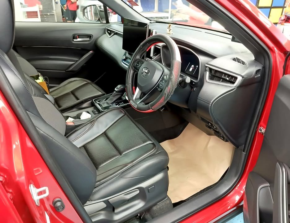 Driver side cabin with black leather seats and the steering wheel.