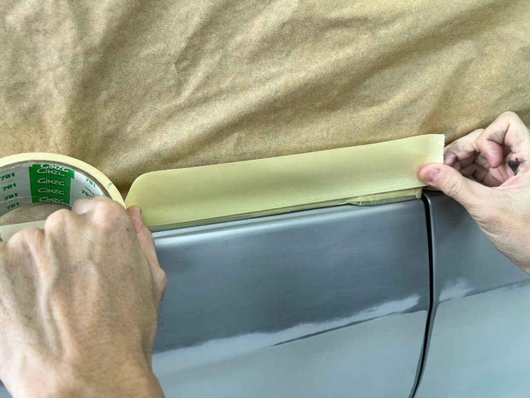 The Estima masked up with paper over all non-painted surfaces before spraying.