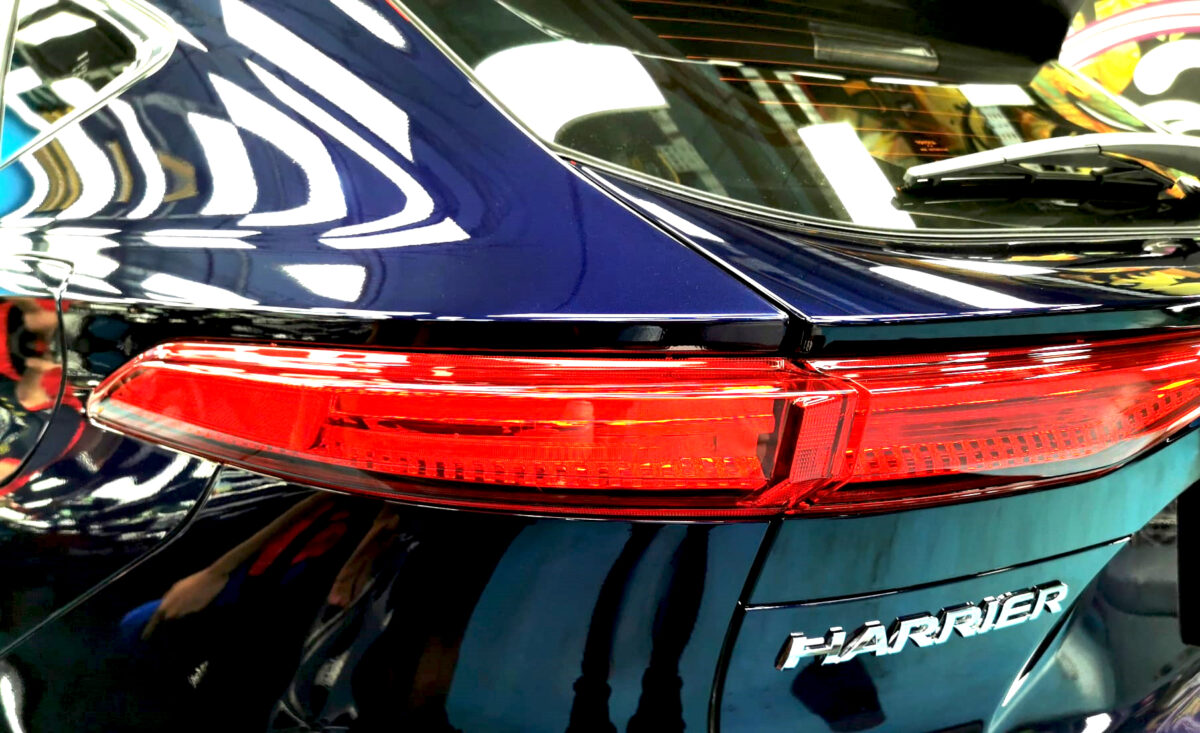 The coated bonnet of the Toyota Harrier under workshop lighting.