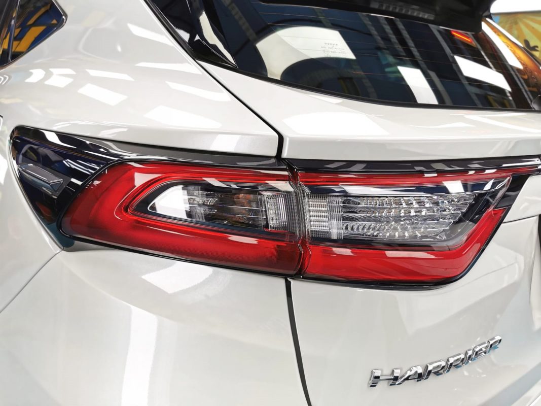 The coated bonnet of the Toyota Harrier under workshop lighting.