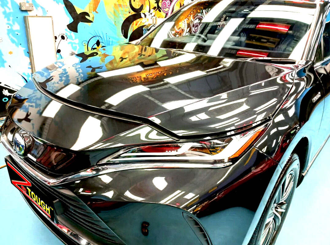 The Toyota Harrier's coated paintwork under workshop lighting.