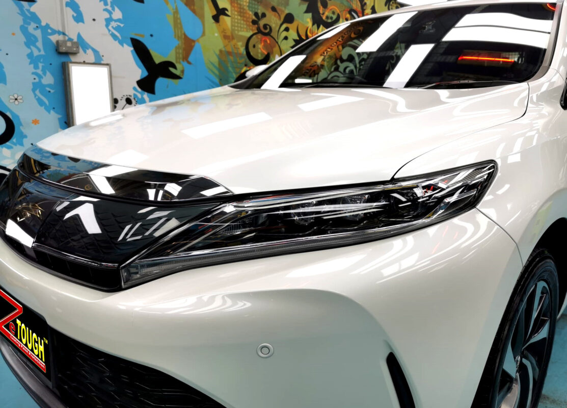 The Toyota Harrier's coated paintwork under workshop lighting.