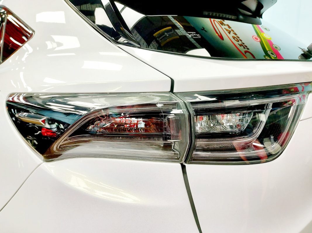 The coated bonnet of the Toyota Harrier Elegance under workshop lighting.