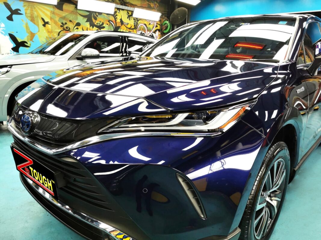 The Toyota Harrier's coated paintwork under workshop lighting.