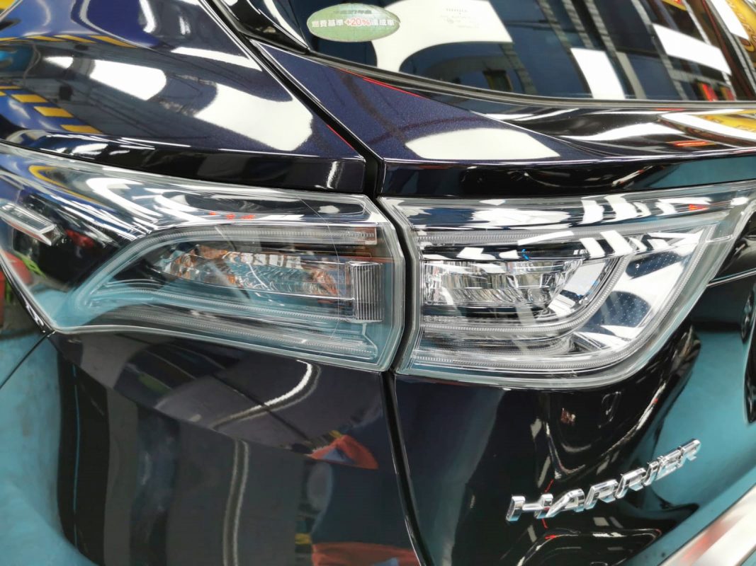 The coated bonnet of the Toyota Harrier under workshop lighting.