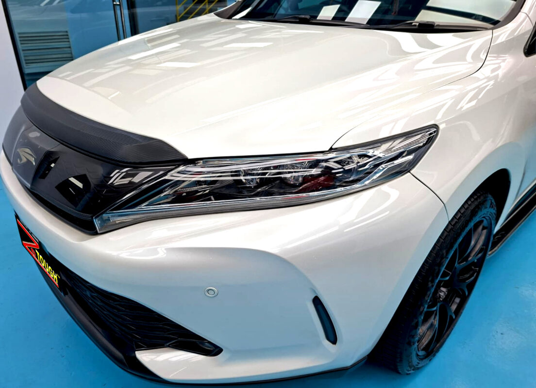 The Toyota Harrier's coated paintwork under workshop lighting.