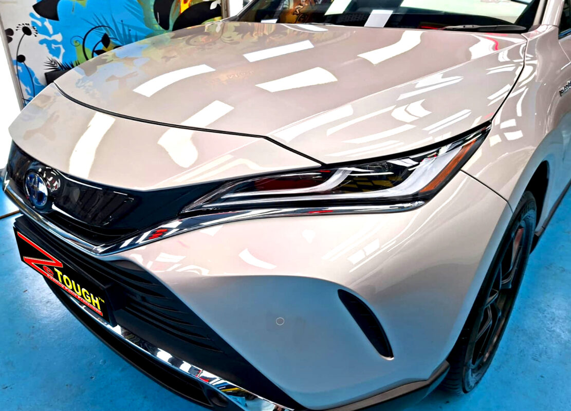 The Toyota Harrier's coated paintwork under workshop lighting.