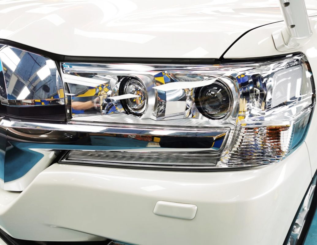 The Land Cruiser's coated paintwork showing clean reflections.