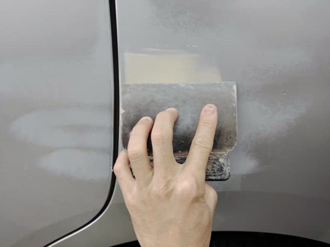 Bodywork repair underway on the Toyota Noah, dents being patched and filled.