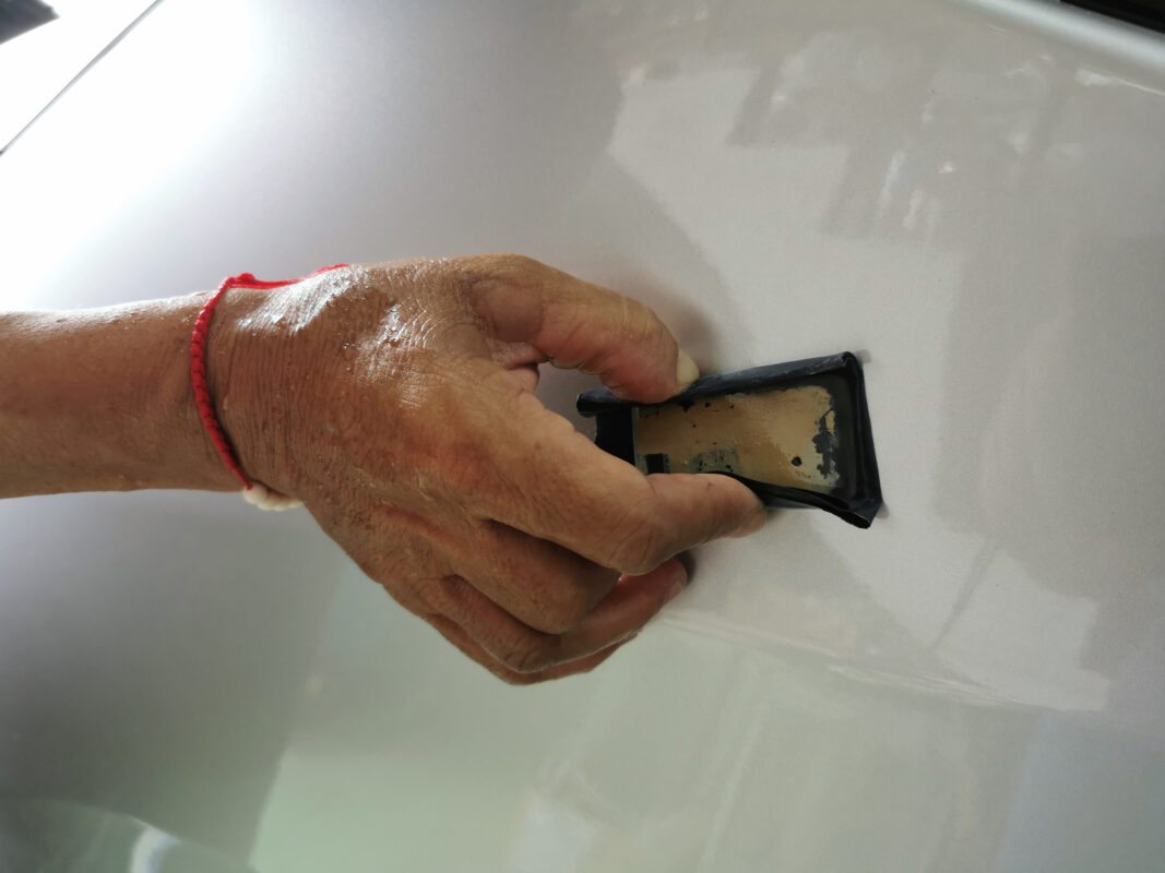 A Revol Carz painter spraying the Toyota Noah in the spray booth.