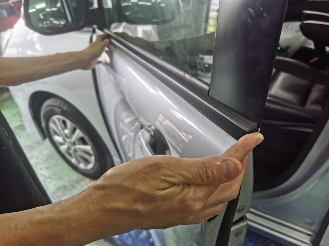 Parts being refitted to the Toyota Noah after the respray.