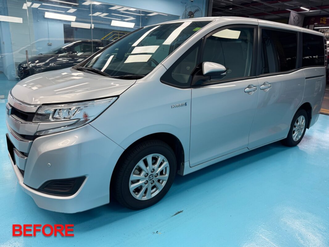 The Toyota Noah at the reveal, fresh paint gleaming under workshop lighting.