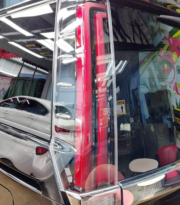 The coated bonnet of the Toyota Noah under workshop lighting.