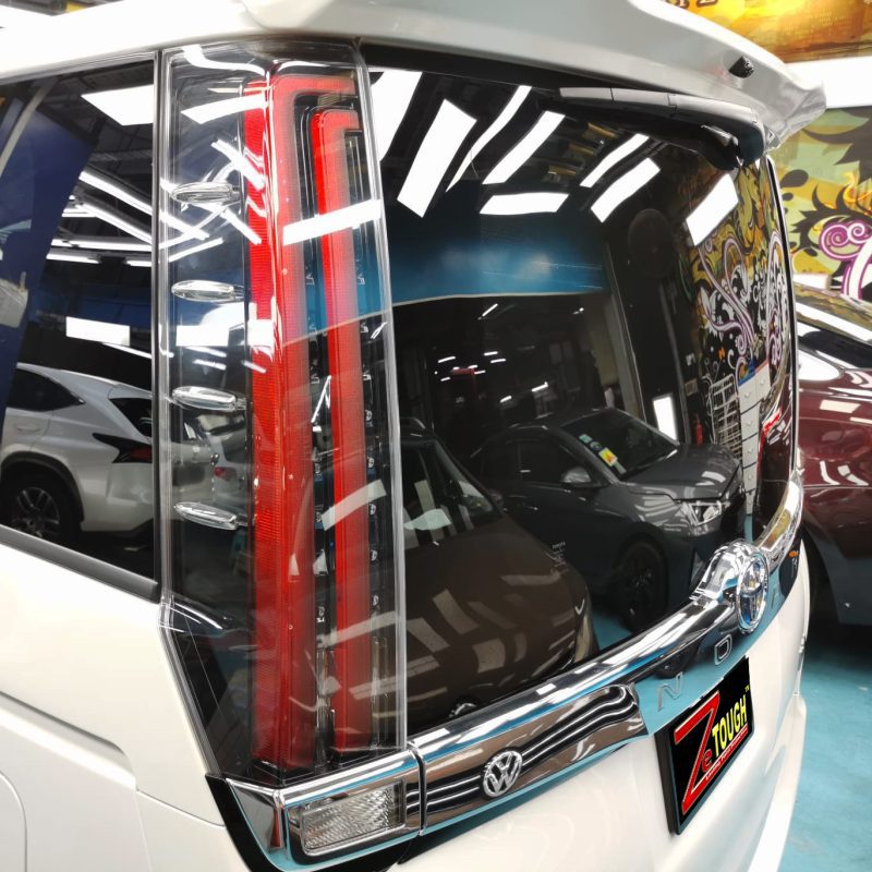 The coated bonnet of the Toyota Noah under workshop lighting.