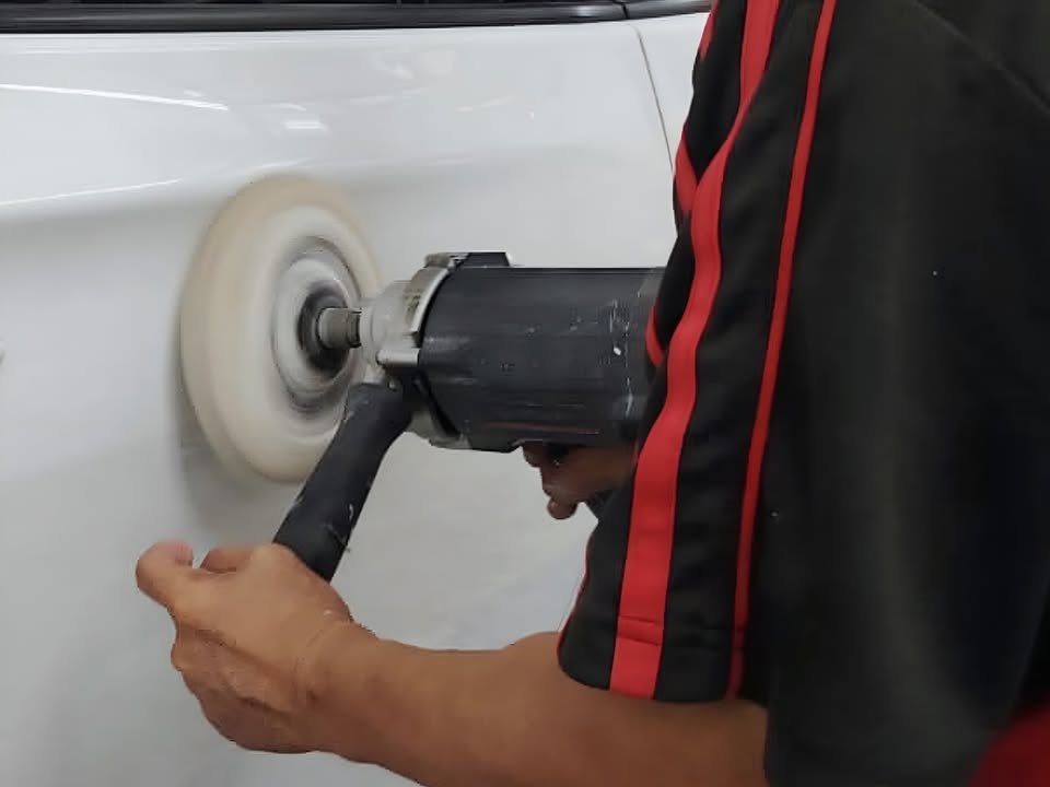 Rotary polisher on the freshly painted white door.