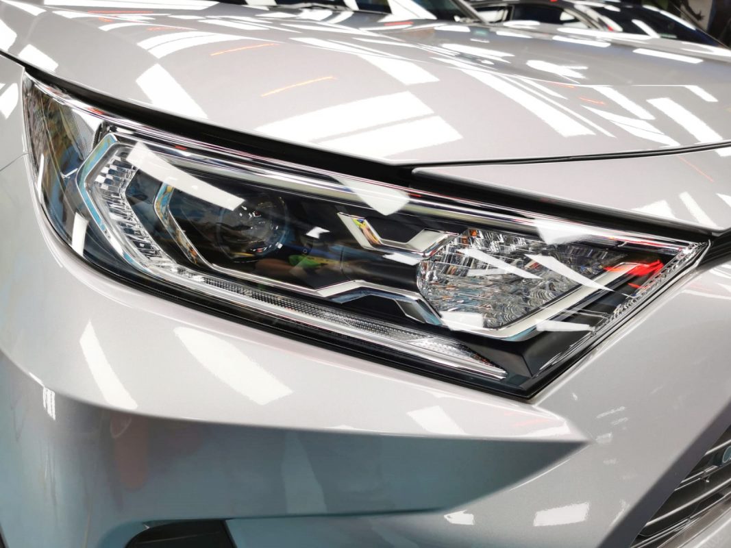 The RAV4's coated paintwork showing clean reflections.