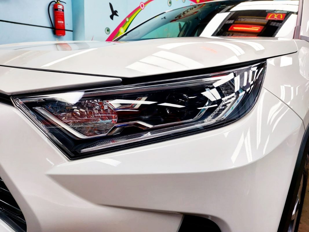 The RAV4's coated paintwork showing clean reflections.