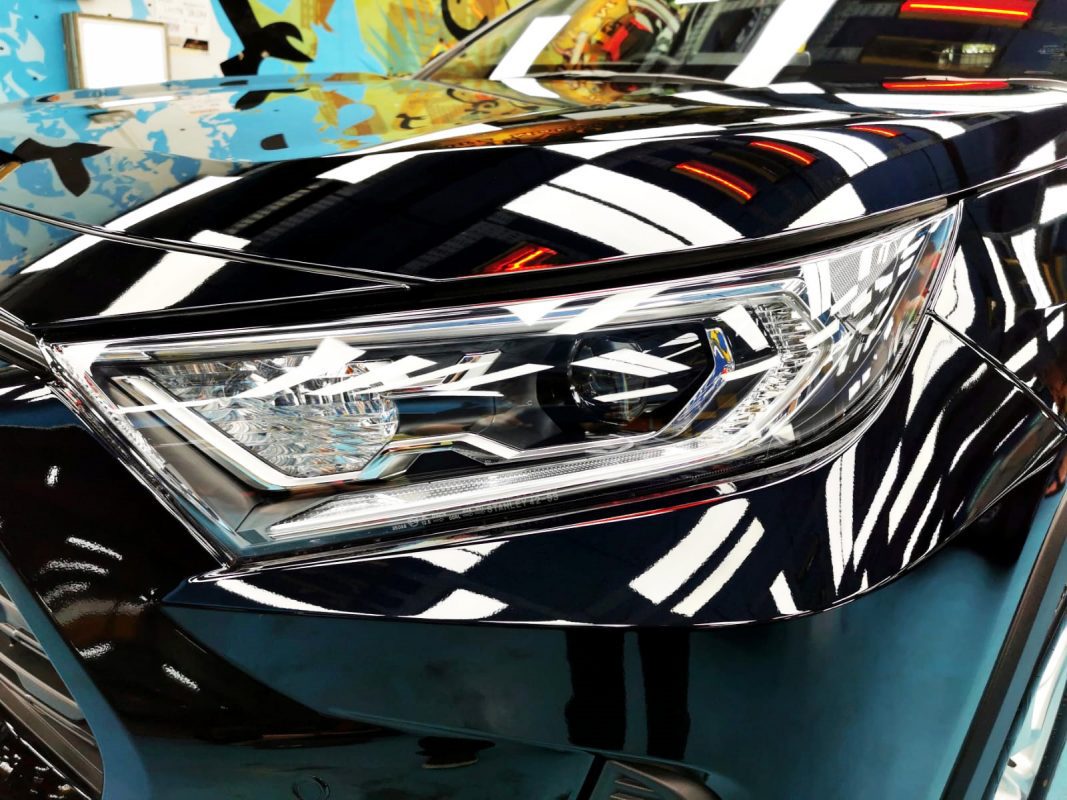 The RAV4's coated paintwork showing clean reflections.