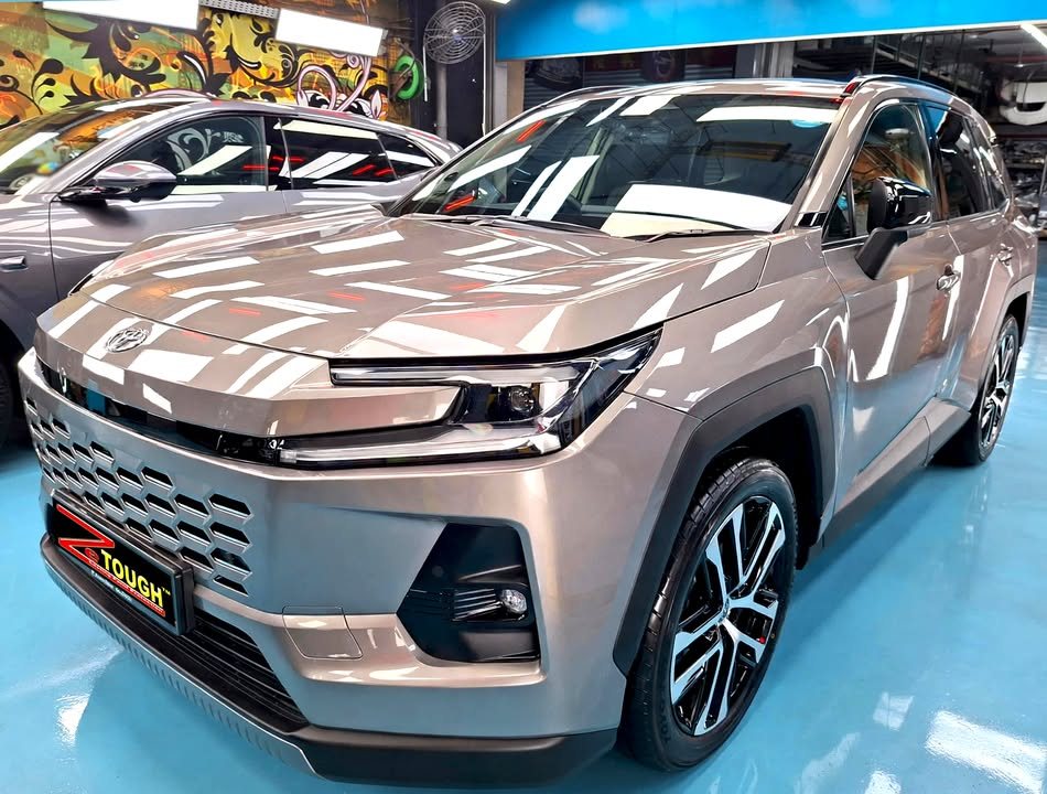 Bronze grey Toyota RAV4, front three-quarter view, in the Revol Carz workshop after coating.