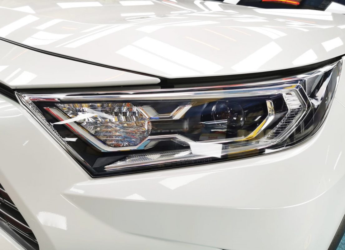 The RAV4's coated paintwork showing clean reflections.