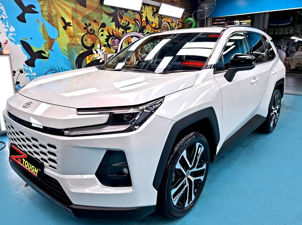 White Toyota RAV4, front three-quarter view, in the Revol Carz Makeover workshop after its ZeTough Titanium coating.